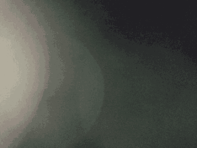 a dark gray background with a few spots of light on it