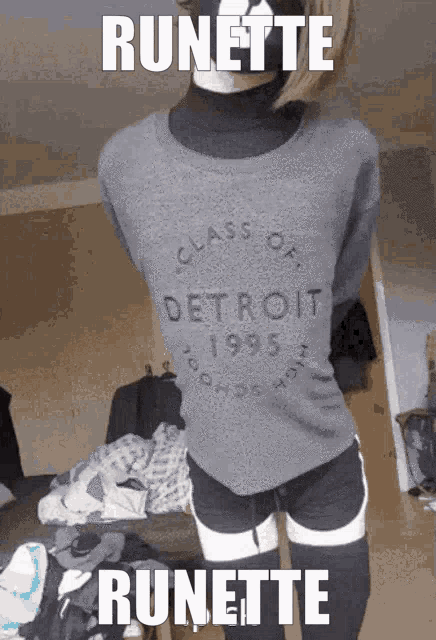 a person wearing a sweater that says class of detroit 1995