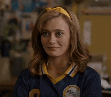a woman wearing a blue and yellow shirt with the number 9 on it