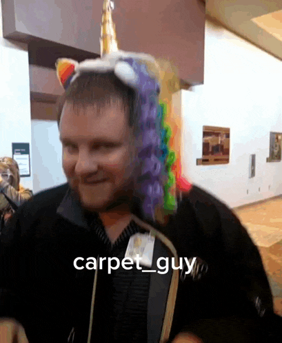 a man wearing a unicorn hat with a tag that says carpet guy on it