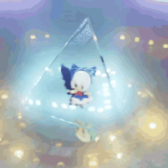 a blurred image of a pyramid with a blue light behind it