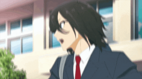 a man in a suit and red tie is running in front of a building .