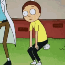 a cartoon character in a yellow shirt is squatting down on the grass .