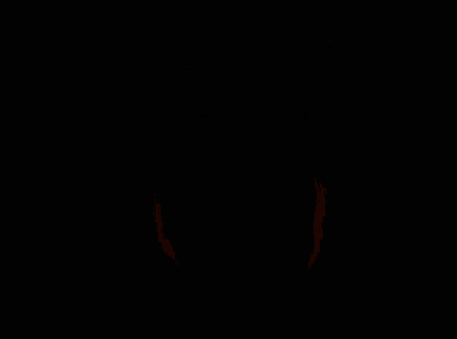 a green object is glowing in the dark in a dark room