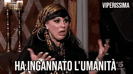 a woman wearing a scarf and hoop earrings is making a funny face while talking .