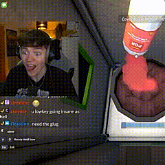 a man wearing headphones is playing a video game while a bottle of mdd is being poured into a cup