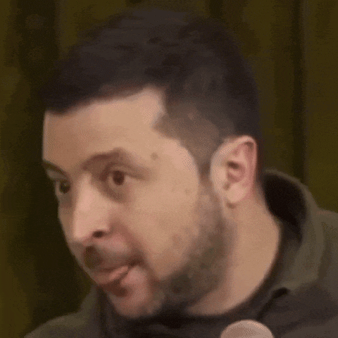 a man with a beard and mustache is making a funny face .