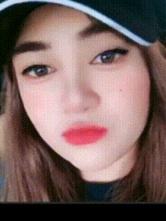 a close up of a woman wearing a baseball cap