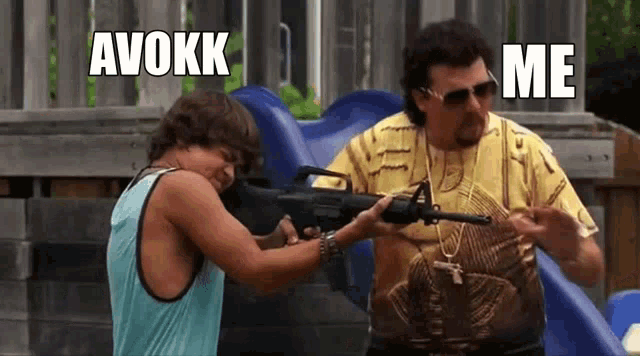 a man is pointing a gun at another man in a playground .