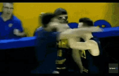 a blurry picture of a wrestling match with the word sport on the bottom