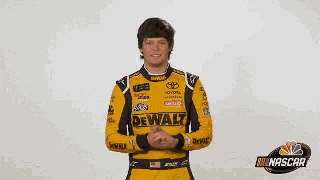 a man wearing a yellow and black racing suit with dewalt written on it