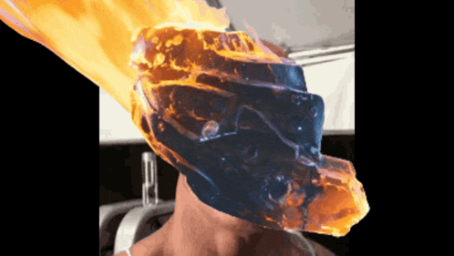 a person 's head is covered in flames and a flame is coming out of it