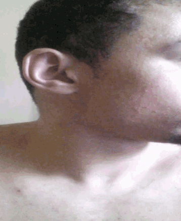a close up of a man 's ear with a beard