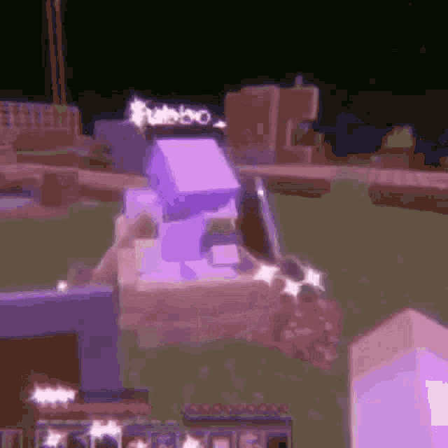 a purple cube is sitting on top of a purple cube in a video game .