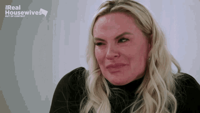 a woman is crying in front of a sign that says real housewives out of context