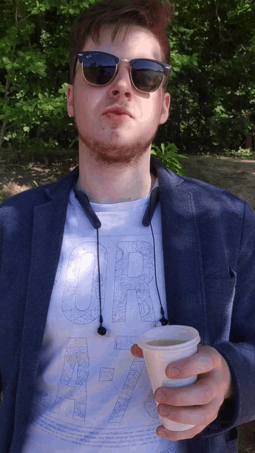 a man wearing sunglasses and a shirt that says " or "