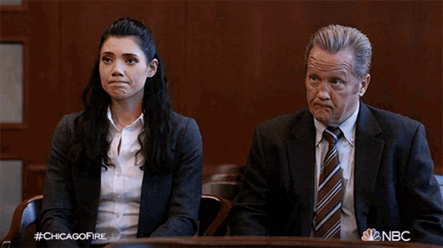 a man and a woman are clapping in a courtroom with the hashtag #chicagofire on the bottom