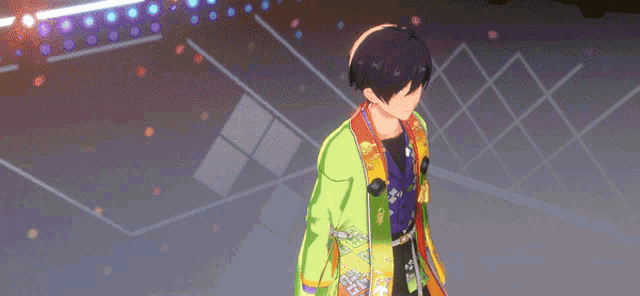 a boy in a green jacket is standing on a stage