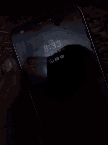 a phone displays the time of 8:33 pm