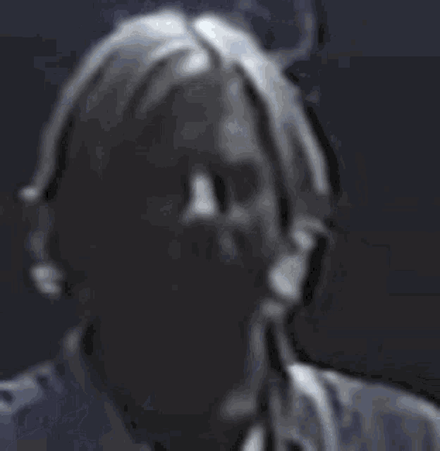 a close up of a person 's face with a ponytail