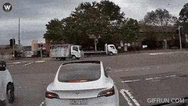 a white tesla with a license plate that says eno 60u