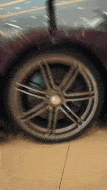a close up of a wheel on a purple sports car
