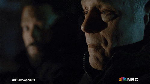 two men are looking at each other with a chicagopd logo in the corner
