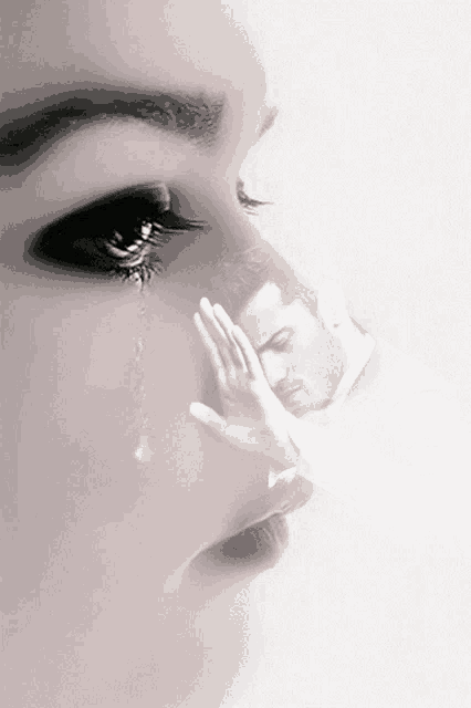 a woman is crying with a hand on her face