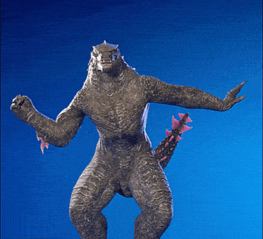 a statue of a monster with its arm outstretched against a blue background