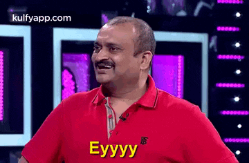 a man in a red shirt is making a funny face and says eyyy .
