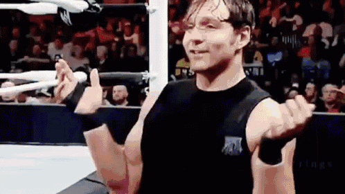a wrestler is giving a thumbs up sign in a wrestling ring .