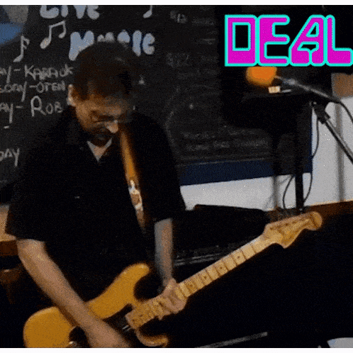 a man is playing a guitar in front of a sign that says de4