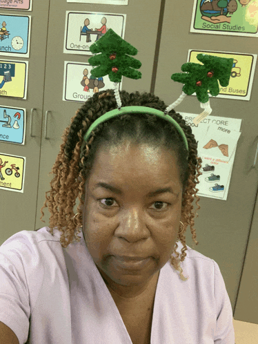 a woman wearing a headband with two trees on it