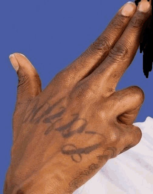 a close up of a person 's hand with a tattoo on it that says `` i love you '' .