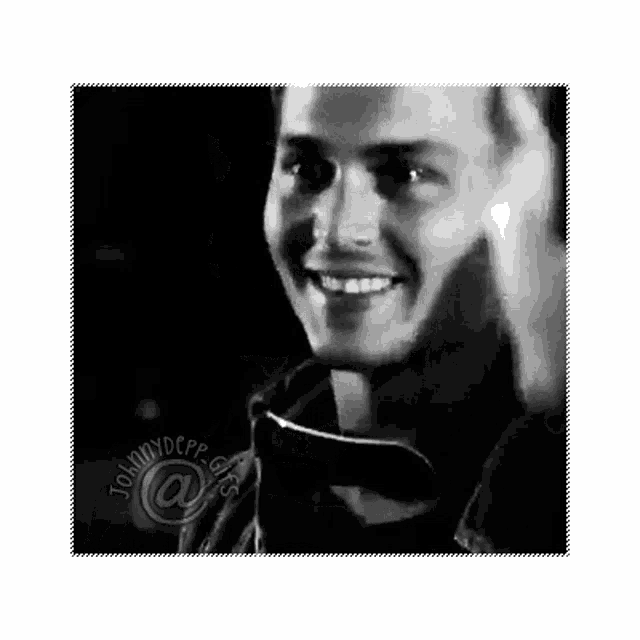 a black and white photo of a smiling man with the name johnny depp on the bottom right