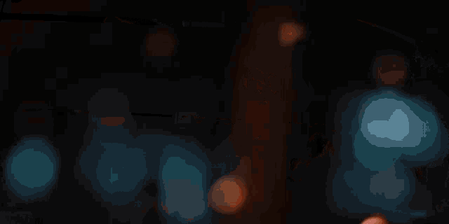 a blurred image of a person holding a piece of paper in a dark room
