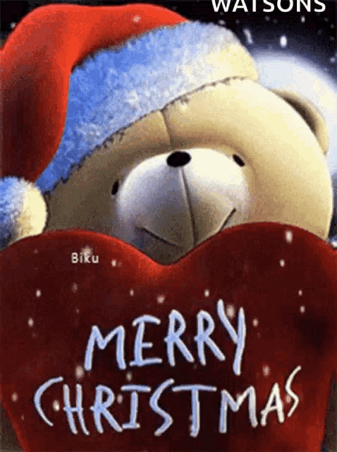 a teddy bear wearing a santa hat is holding a red heart with merry christmas written on it