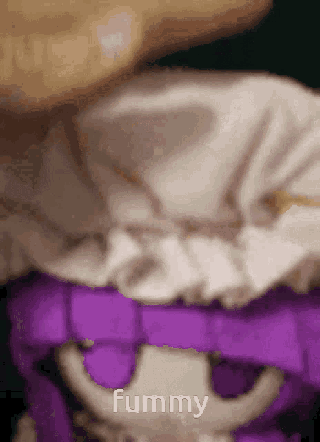a close up of a stuffed animal with the words fummy written on it