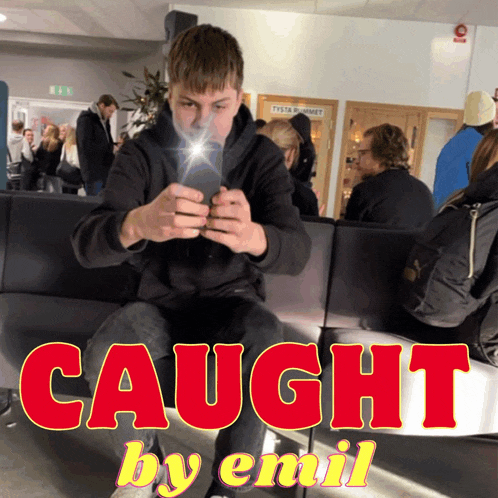 a man is sitting on a couch with the words caught by emil on the bottom