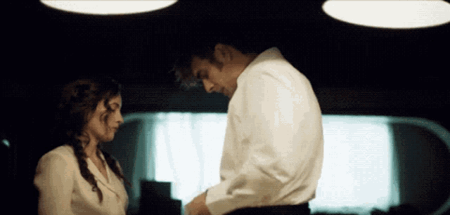 a man and a woman are looking at each other