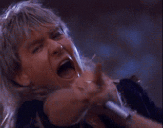 a woman is singing into a microphone with her mouth open
