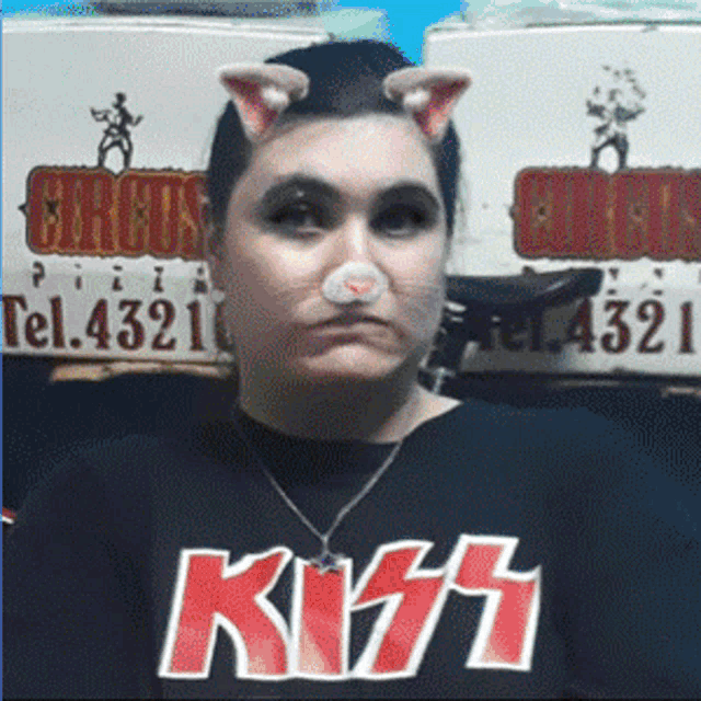 a woman wearing a black shirt with kiss on it