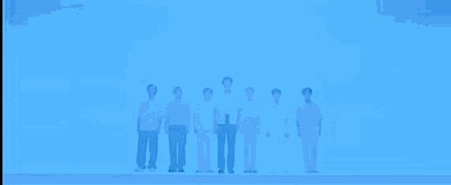 a group of people standing next to each other on a blue background .