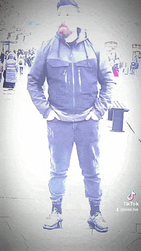 a man standing on a street with his hands in his pockets and a tiktok watermark