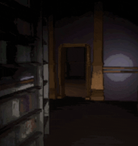 a dark room with a purple light shining through the doorway