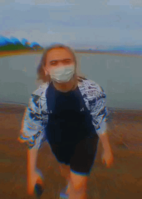 a blurry picture of a person wearing a mask and a black shirt with the letter j on it