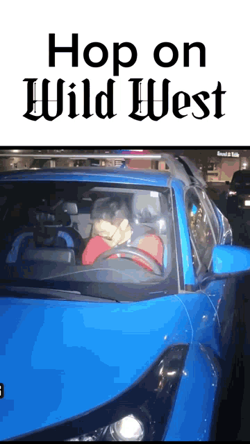 a man is driving a blue car with the words hop on wild west above him