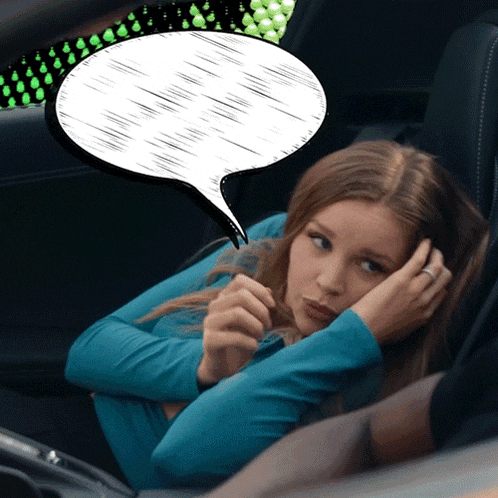 a woman in a car with a speech bubble above her
