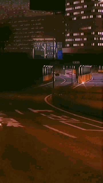 a car is driving down a highway at night with a green sign that says ' tokyo ' on it