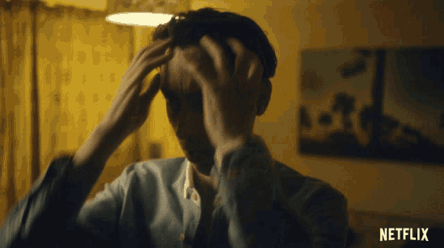 a man with his hands on his head and a netflix logo in the corner
